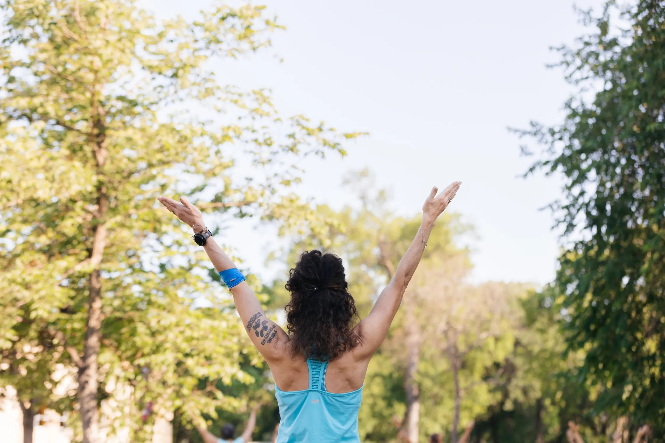 A woman doing yoga in a park.