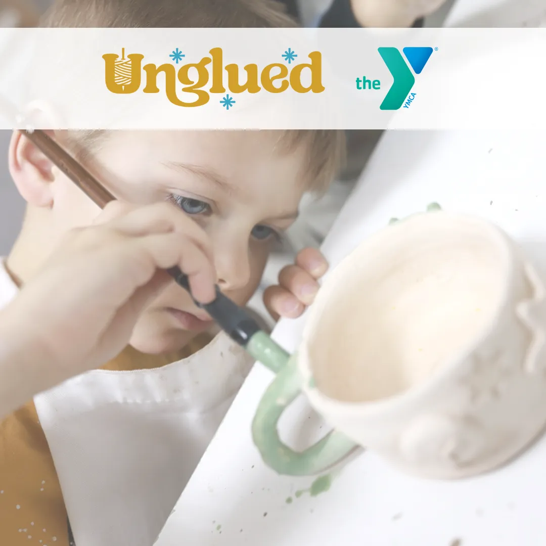 photo of child painting mug